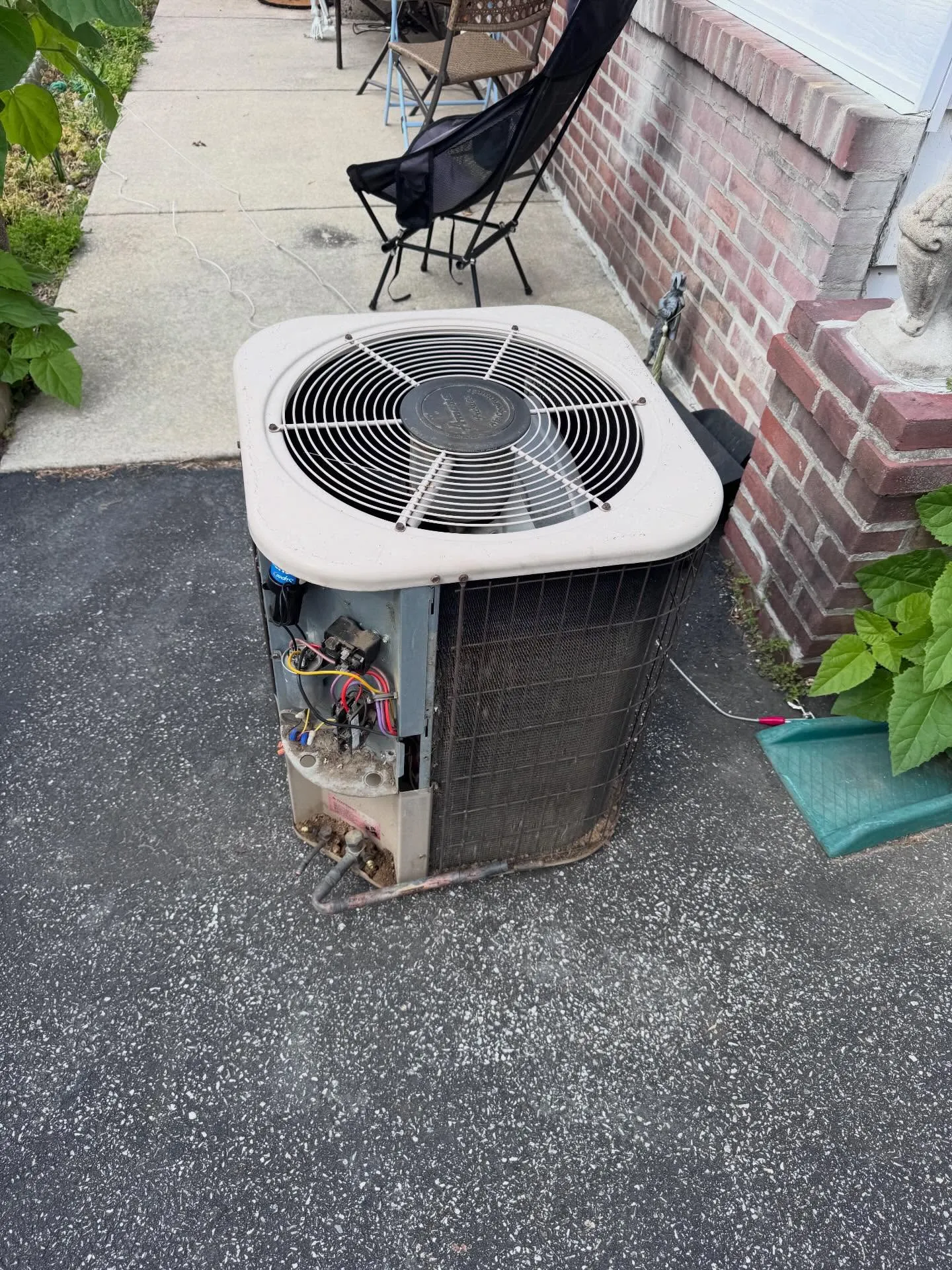 A worn-out central AC condenser pulled for replacement in South Philadelphia