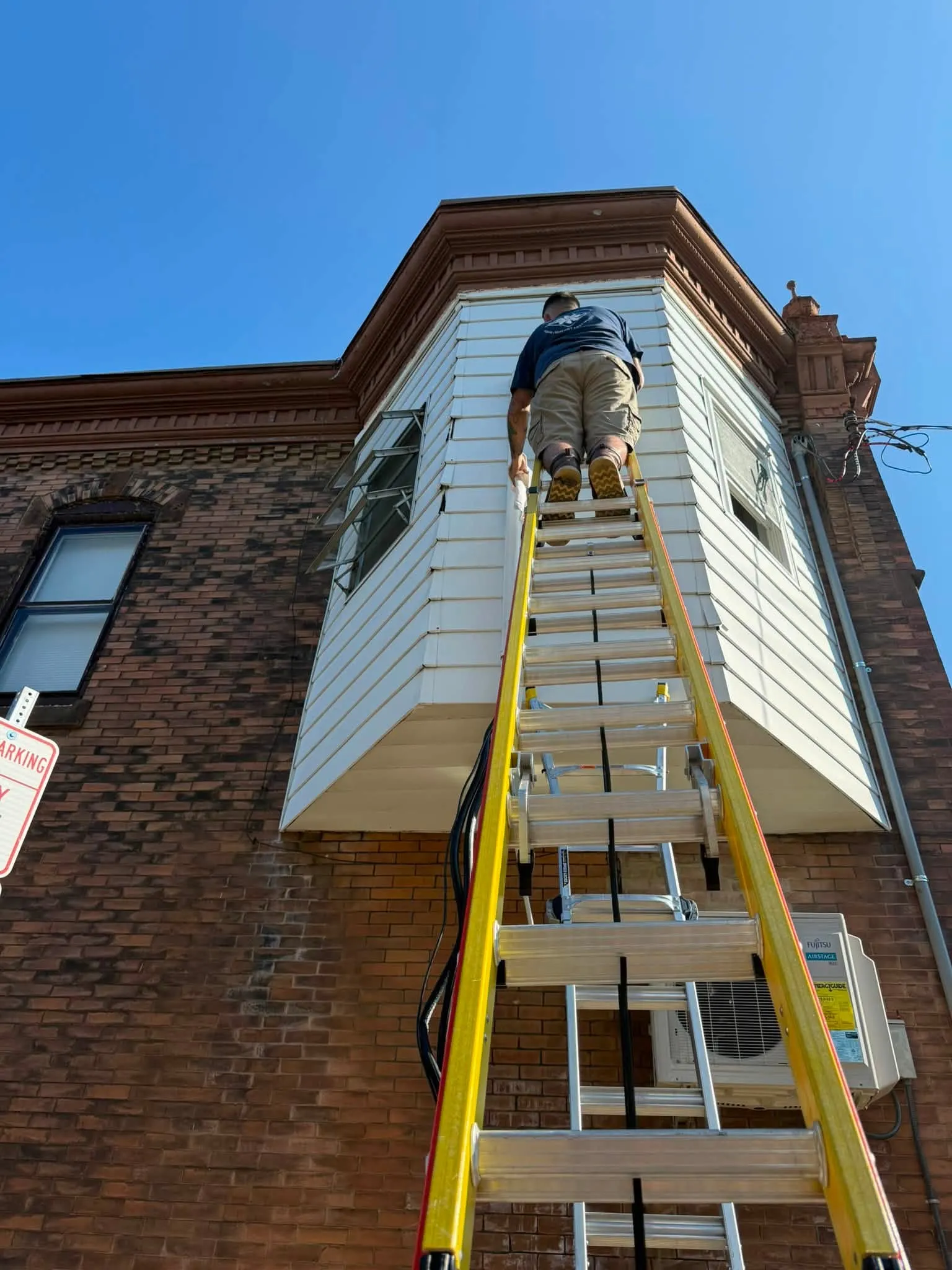 Piccione's technician installing a ductless condenser on a South Philadelphia rowhome
