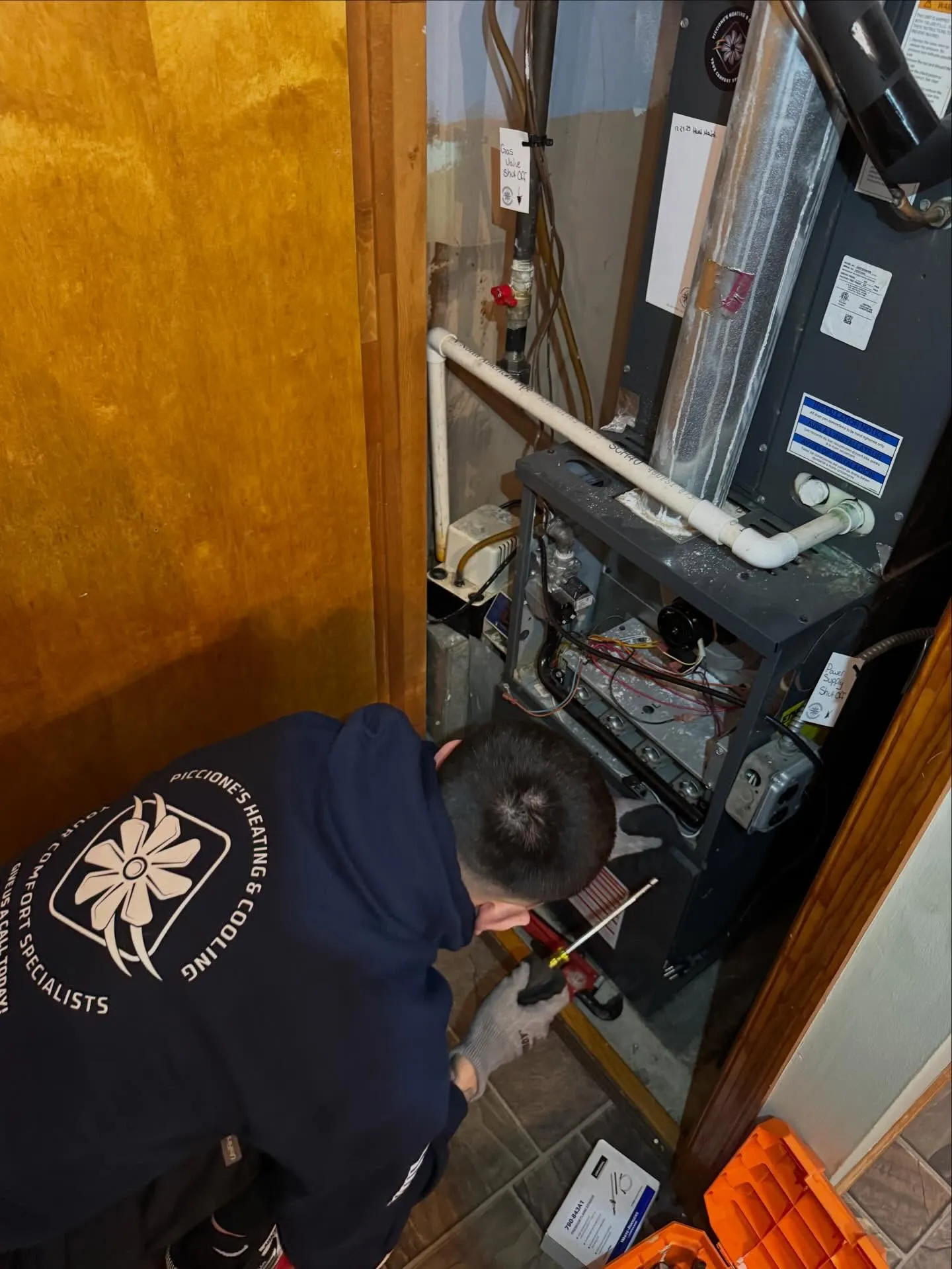 Piccione's technician repairing a gas furnace in a South Philadelphia home